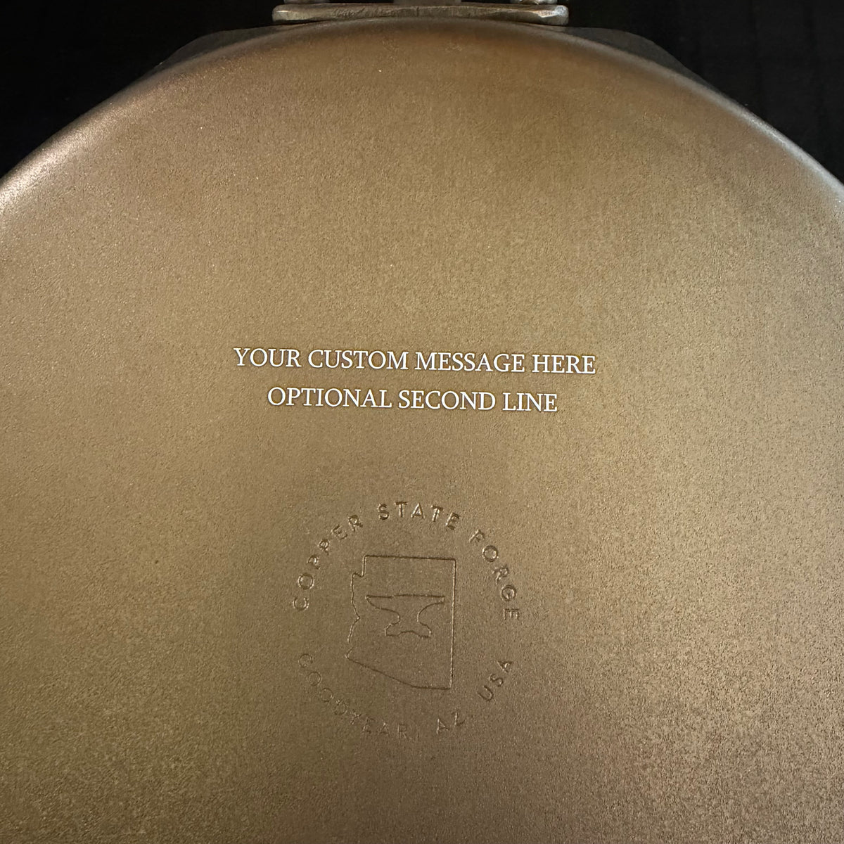 Custom engraving example on the bottom of the Sonoran Griddle with Copper State Forge logo