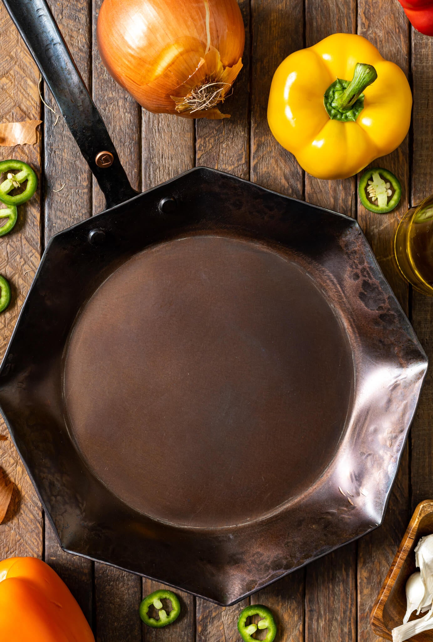 https://copperstateforge.com/cdn/shop/products/forged-10-inch-octagon-pan-top-vegetable-background.jpg?v=1653865667&width=1445