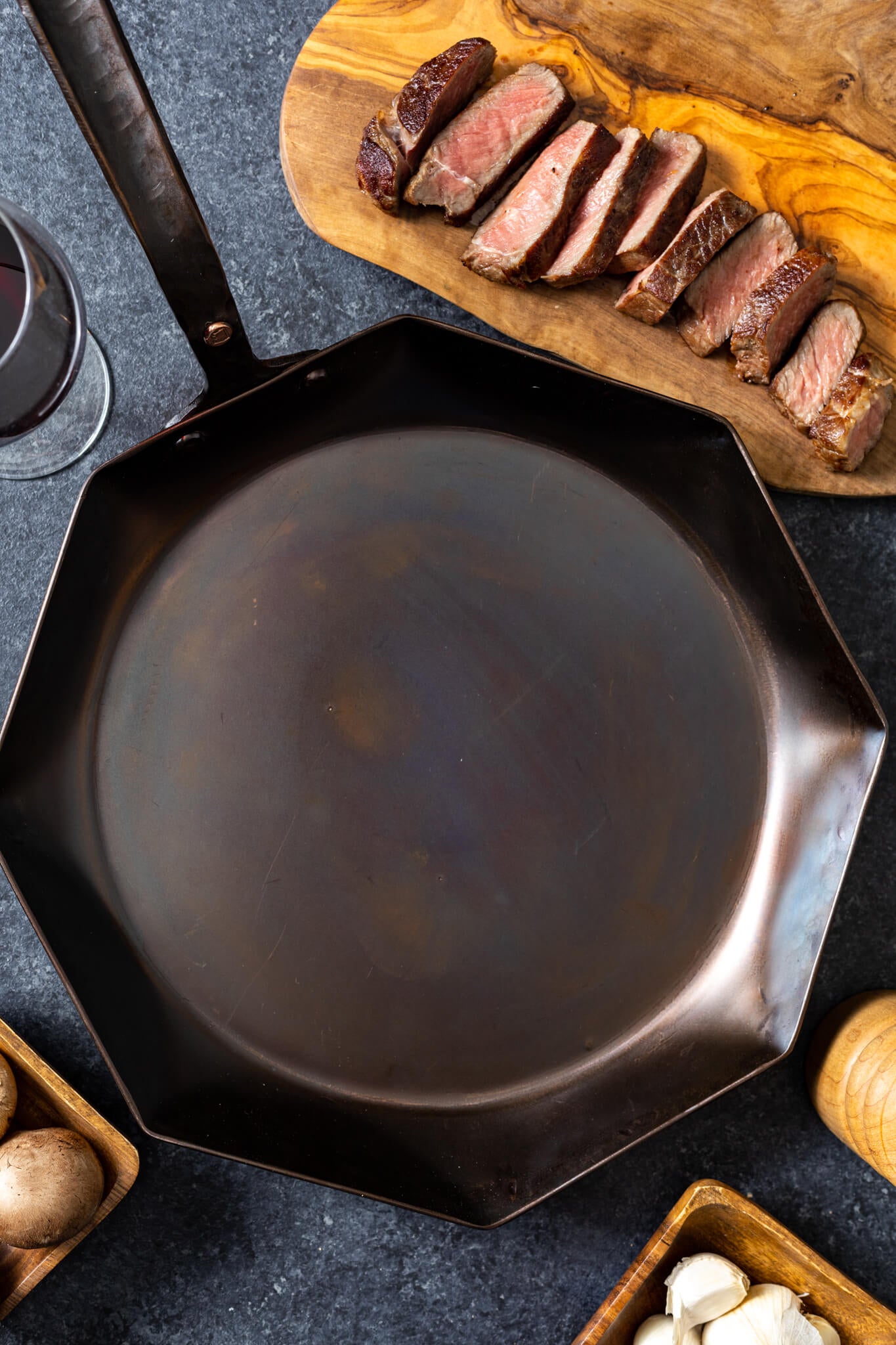 https://copperstateforge.com/cdn/shop/products/forged-12-inch-octagon-pan-top-steak-background.jpg?v=1653865850&width=1445